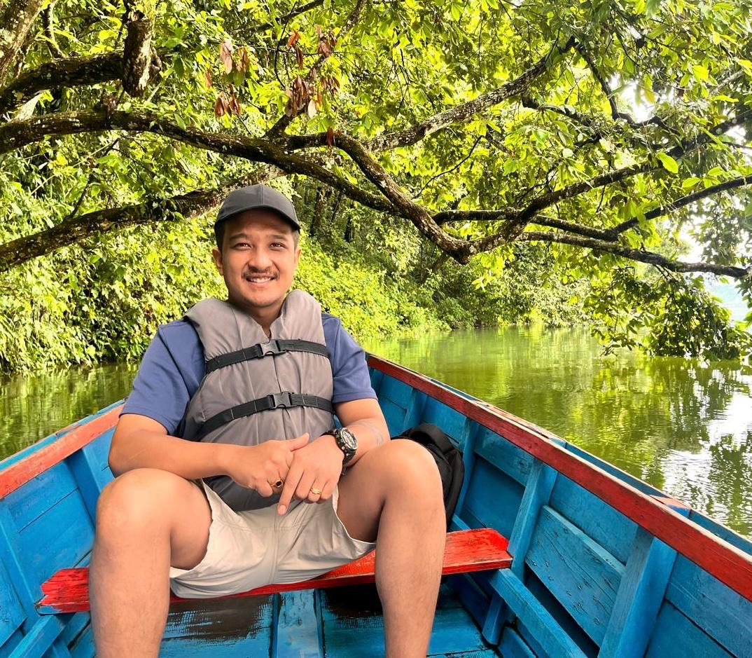 Namah Shrestha outdoors on a boat